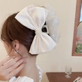 Elegant white satin bow hair clip with luxury pearl accent shown on a model - Claw Clip-Beige Sequin Bow