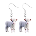 Detailed close-up of cute 3D acrylic white calf earrings with silver metal hooks - Cow