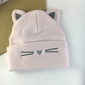Close-up of pink knit cat ear hat with heart nose embroidery and soft texture - Light Pink