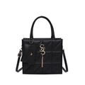 Black quilted faux leather tote bag with gold metal logo and tassel charm detail - Black