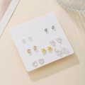 7-day fashion earring set with heart and floral designs on white display card - Hollow Heart Yellow Flower Style (E1986-1)