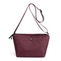 Minimalist burgundy nylon dumpling crossbody bag with adjustable strap and front pocket - Fuschia