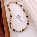 Macro detail of tiger eye beads and heart pendant necklace in vintage jewelry box - 18# Gold-Coffee