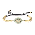 Detail of 18K gold plated evil eye bracelet with blue zircon and black braided cord - Gold