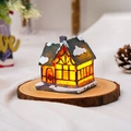 Macro view of a glowing resin Christmas snow house on a wooden base with festive lights - Style D