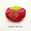 Detailed view of red plush persimmon doll with gold 'Ji' embroidery, size 4x5.5cm - Lucky Persimmon