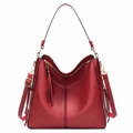 Detailed view of the dark red faux leather tote bag with long tassel and gold hardware - Red