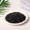 Natural black crystal stones in a white ceramic bowl with green leaves background - Obsidian (3-5mm) 100g