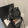 Chic black drawstring bucket bag in textured faux leather with cute plush toy pendant - With Pendant / Black