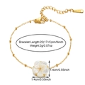 Detail view of 18k gold plated bracelet showing 22cm adjustable length and shell flower charm - Gold B02765G