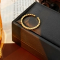 Close-up of vintage golden ring with beaded texture on a black jewelry box - Vintage Beaded Opening Ring / Gold