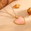 Detail shot of heart pendant necklace with pink enamel and gold beaded chain on rustic wood - Gold Pink Shell Necklace