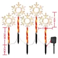 Solar outdoor snowflake pathway lights with festive candy cane poles for Christmas decor - Snowflake (Red Tube)