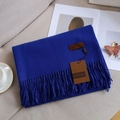 Solid royal blue cashmere-feel scarf with tassels and leather label on sofa - 35# Royal Blue