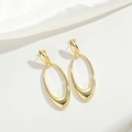 Exaggerated hollow oval gold earrings on white silk background in minimalist style - Hollow Rhombus