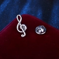 Elegant silver treble clef music note lapel pin on red velvet background - Silver Music Note