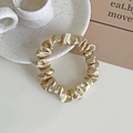 Elegant champagne gold satin scrunchie with a glossy texture and elastic inner band - Champagne