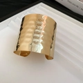 Macro shot of gold hammered metal cuff bracelet with irregular wrinkled texture details - Hammered Wide Style (1#) / Gold