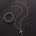 Detailed set of gold-plated nail cross pendant, matching bracelet and ring on dark surface - Spring 3-Piece Set / Gold