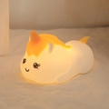 Unicorn silicone night light with orange mane emitting warm yellow glow in soft setting - Lying Unicorn (Battery-7 Colors)