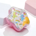 Detailed close-up of pink star-shaped hairbrush with moving star sequins and unicorn motif - White Base Pony