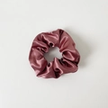 Close-up of a dusty rose satin scrunchie with glossy silk-like pleated fabric texture - Without Card / Deep Pink
