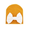 Ginger yellow knitted baby hat featuring a large decorative white bow on a white background - 0-6 Months / Ginger and White
