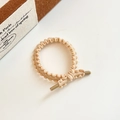 Elastic knit hair tie in apricot beige featuring wavy texture and resin cylinder accents - Beige Coffee