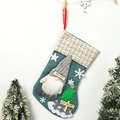 Green Christmas stocking with gnome doll and Merry Christmas text on rustic wood sign - Large Blue Fence Christmas Stocking