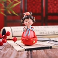 Macro detail of Chinese style girl figurine on red base with traditional props - Maiden Holding Fan (1088-37) / Small