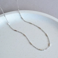Minimalist silver geometric necklace with rectangular cubes on a white ceramic tray - Platinum Plain Chain