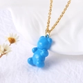 Golden necklace featuring a vibrant blue gummy bear pendant with a glossy finish - Blue