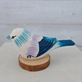 Hand-painted wooden bird sculpture featuring vibrant blue and purple stripes on a log base - 4-Blue Purple Striped Bird (With Base)