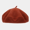 Close-up of a retro red-brown wool felt beret showing soft texture and top stem detail - One Size / Rust Red