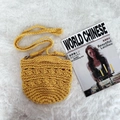 Macro view of ginger yellow crochet handbag showing thick woven strap and popcorn texture - Yellow