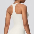 Detail view of the racerback design and elastic fabric on a cream sports bra - S / Light Ivory