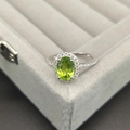 Elegant 925 sterling silver ring featuring an oval green peridot gemstone and white accents - Size 5 / Peridot