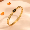 Detail shot of a gold-plated sawtooth bracelet featuring a black enamel oval inlay - Gold (Black Oval Enamel)
