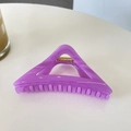 Close-up of a 12cm purple triangular hair claw clip with golden metal spring detail - Transparent Purple
