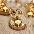 Golden heart-shaped metal candle holder with deer silhouette and tea light on wood - 8.5x10x10cm