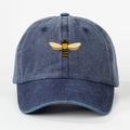 Washed navy blue denim baseball cap featuring a yellow and black honey bee embroidery - One Size / Navy Blue