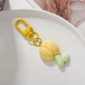 Detailed view of yellow tulip flower keychain with matching metal ring in white bowl - Light Yellow Tulip