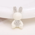 Detailed close-up of a white rabbit-shaped resin charm with sparkling rhinestone inlay - White Rabbit