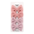 Detail view of 4-piece set of pink textured fabric bow hair clips on display card - Pink/Lotus Color