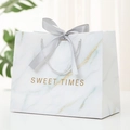 White marble pattern gift bag with silver satin bow and Sweet Times gold lettering - White Sweet Times