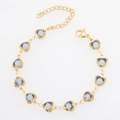 Detail of gold heart bracelet with blue glass stones, lobster clasp and extension chain - Gold + Blue