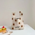 Detail of soft beige knitted tote bag with brown bear patterns and bear embroidery - Full Bear Print Beige