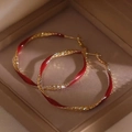 Macro shot of red enamel and gold-plated twisted hoop earrings in a jewelry box - 50# Silver Needle - Eco - Red