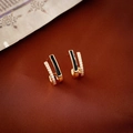 Macro detail of gold U-shaped earrings with black enamel inlay and zircon micro-pave - Silver Needle - Black Zircon Enamel Double Layer Stud Earrings