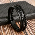 Detail of woven leather bracelet with lava stone beads and black magnetic clasp - 19cm / Black